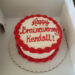 a circular cake with the words ' happy brainaversary kendall!'